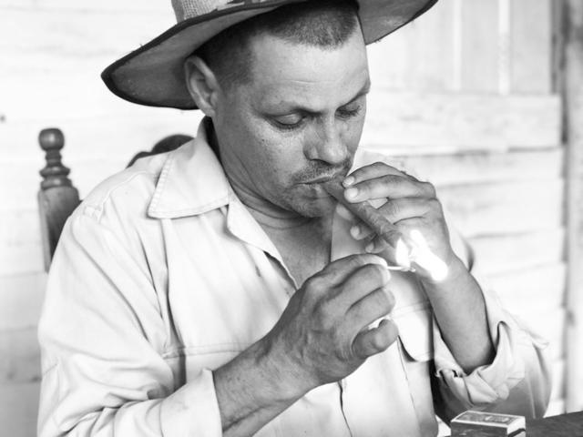 Farmer lighting a cigar in Vinales